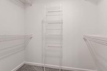 a room with two white closets and a white wall at Latitudes Apartments, Indianapolis